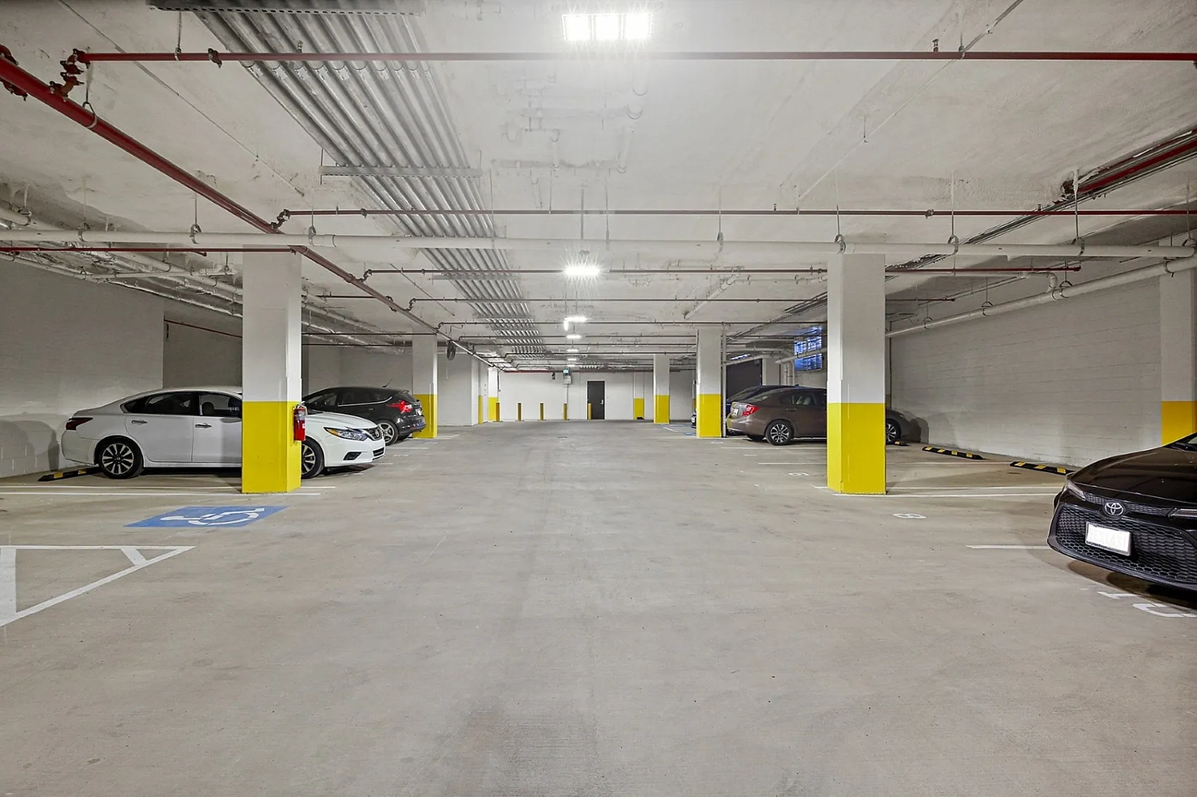 Spacious, well-lit underground parking garage with modern design and convenient accessibility.