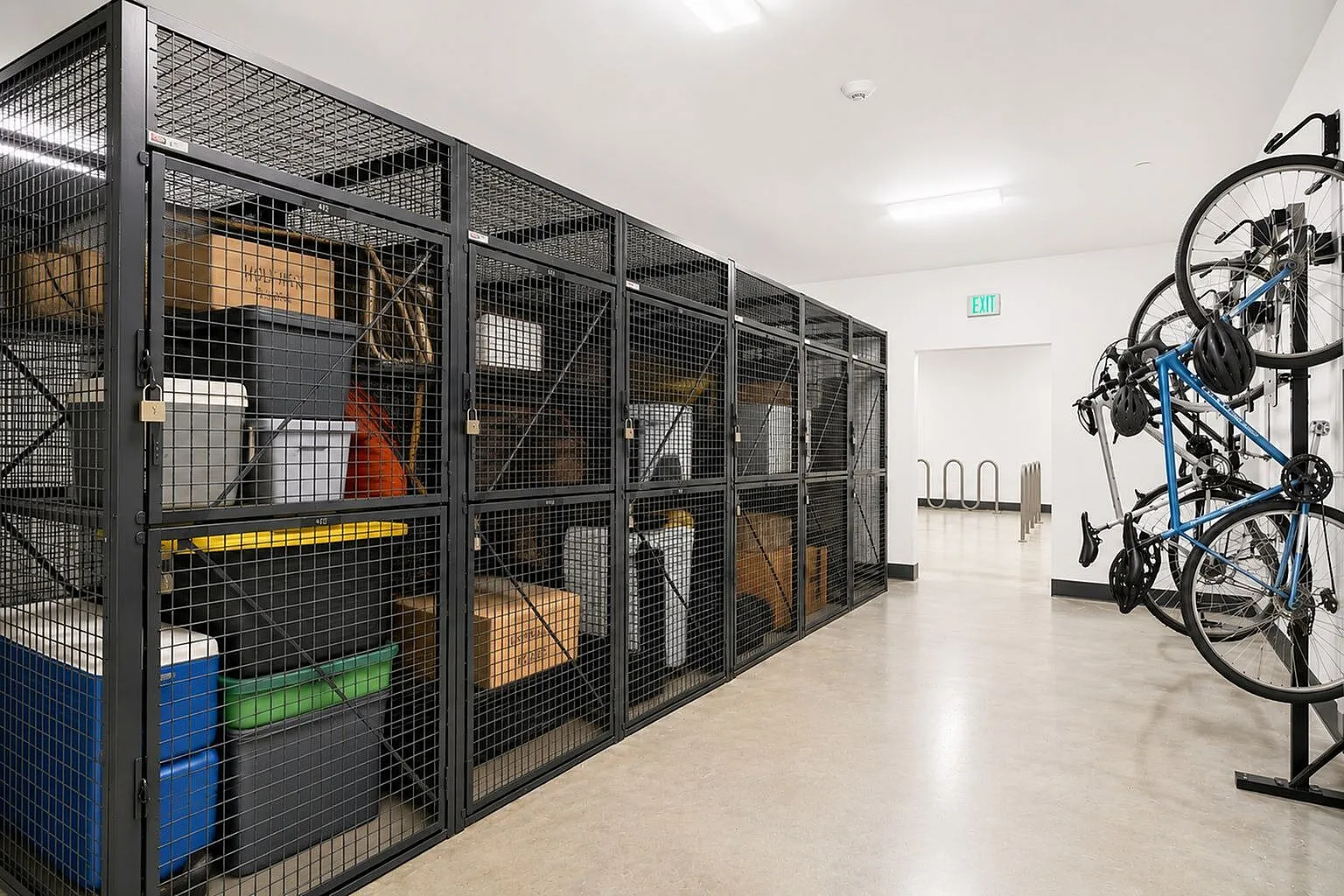 Secure storage area featuring organized lockers for personal items and convenient bike racks in a modern apartment complex.