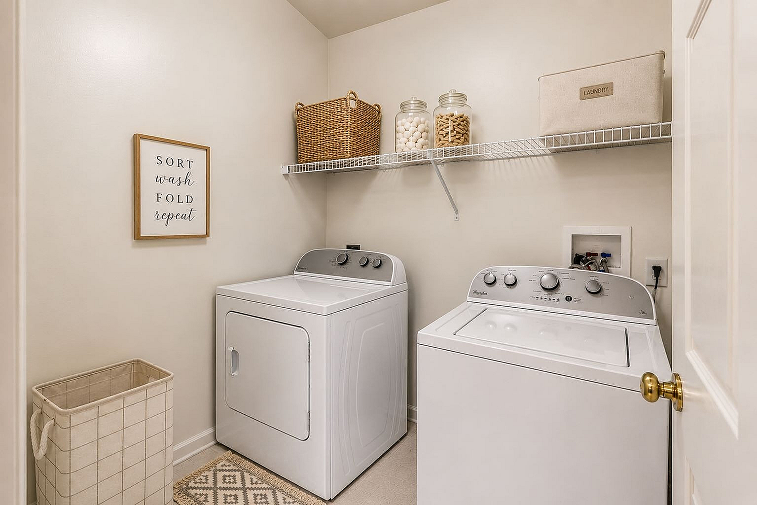 Chic laundry room with modern washer and dryer, stylish storage solutions, and elegant decor for organized living.
