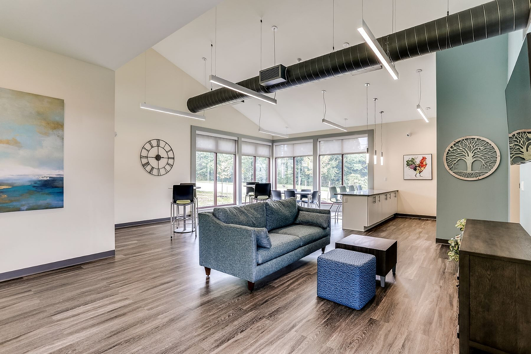Modern, open-concept living area with abundant natural light, featuring stylish furnishings, sleek flooring, and a spacious layout ideal for relaxation and entertainment.