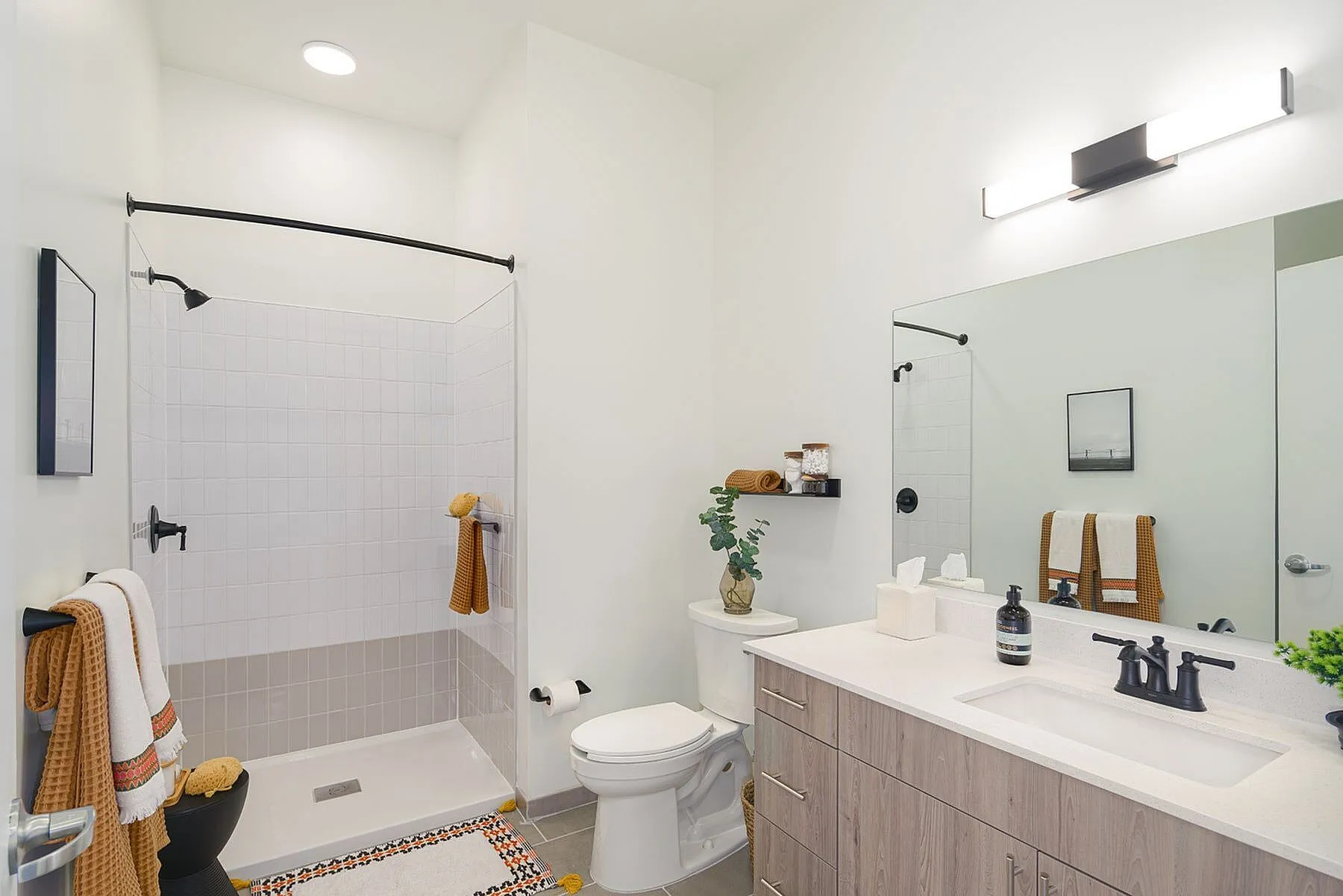 Elegant bathroom with modern fixtures, spacious walk-in shower, and stylish vanity, creating a serene oasis.