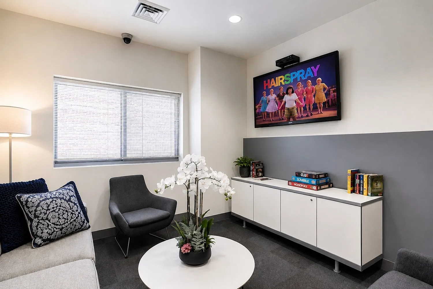Chic lounge area with cozy seating, modern decor, and a wall-mounted TV perfect for entertainment.