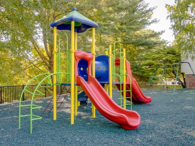 Playground with multiple slides and pieces for climbing.