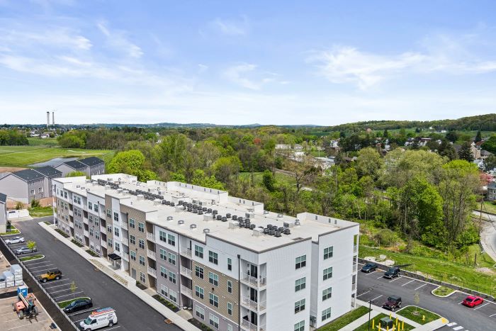 Aerial view of Emerson Flats, a controlled access apartment complex at the corner of a road.