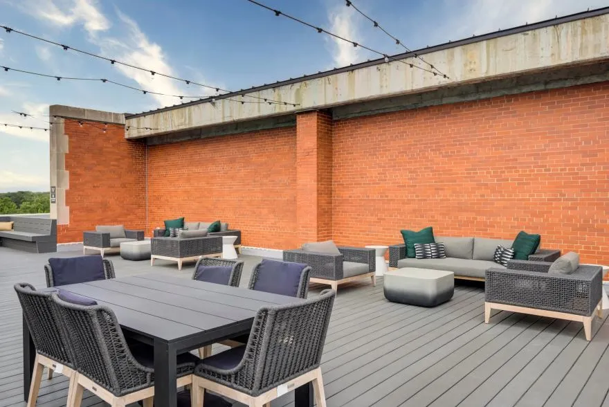 A stunning rooftop patio at the Model Tobacco Apartments, offering breathtaking views of New York City’s skyline.