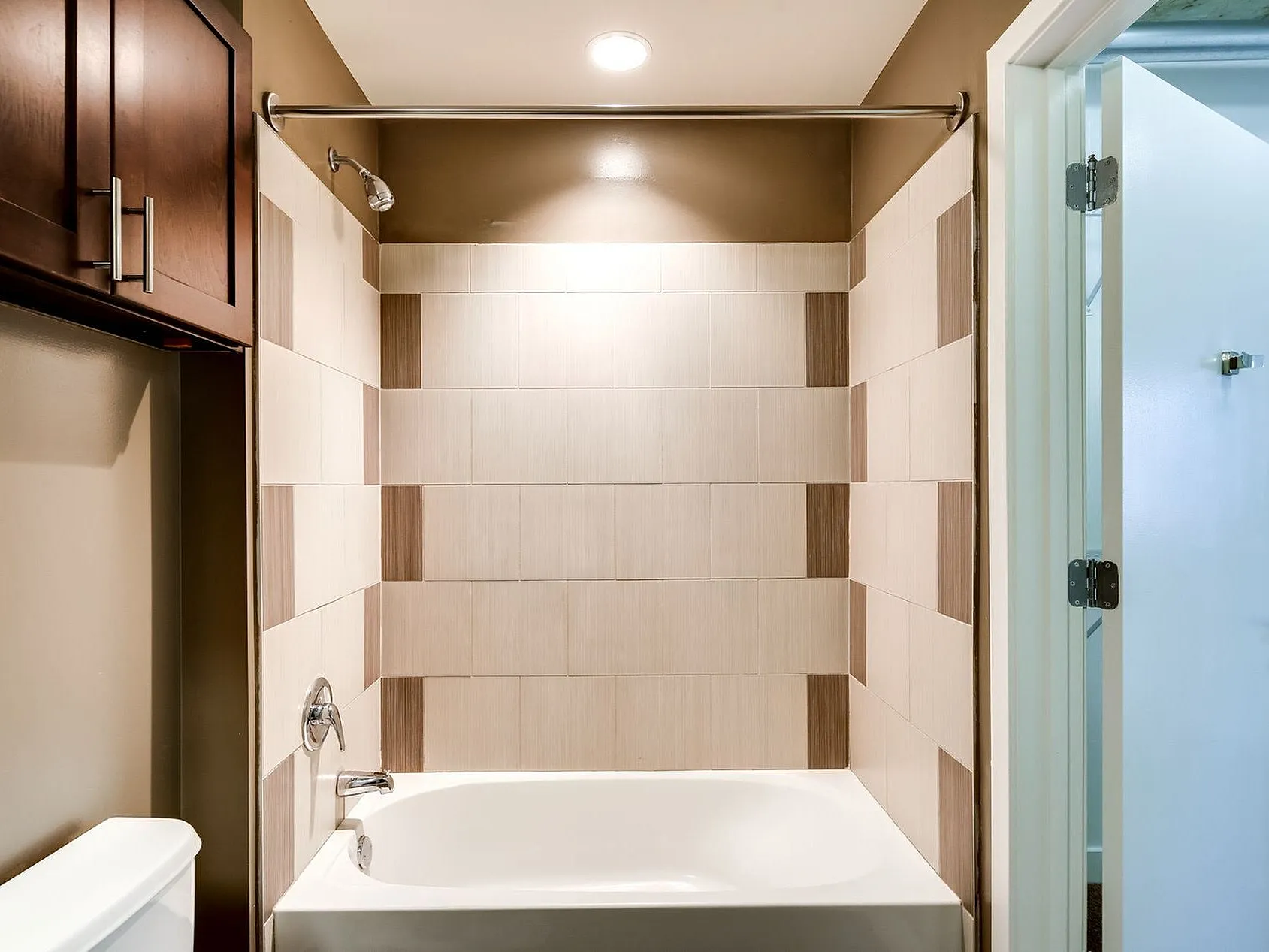 Contemporary bathroom with elegant tile design and sleek bathtub, offering a relaxing oasis in the home.