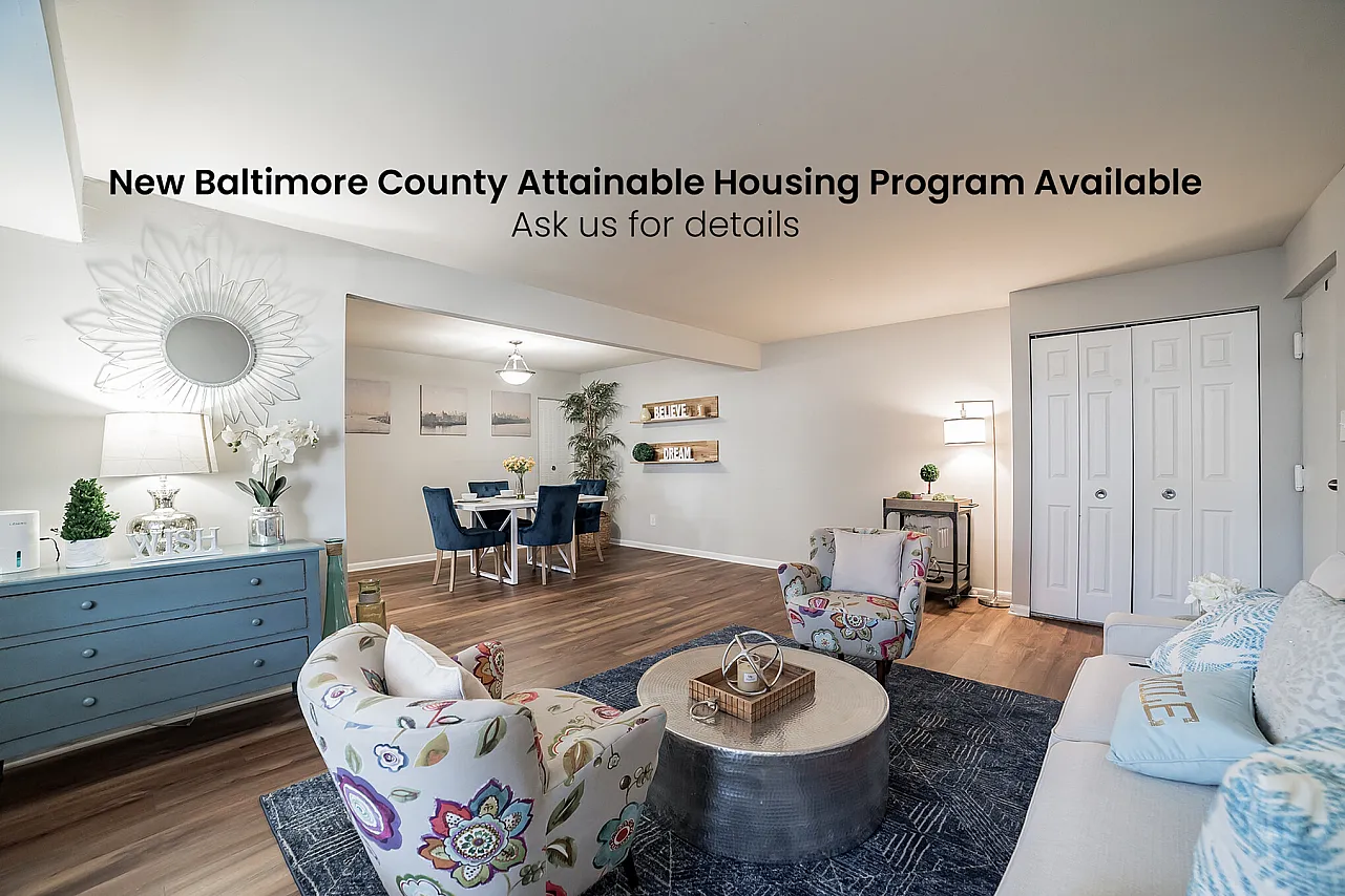 Spacious living room with modern decor and dining area in Baltimore County apartment.