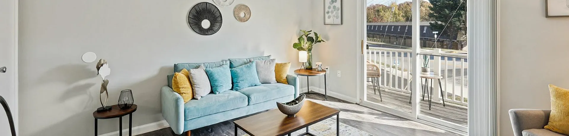 Bright and stylish living room with modern decor and large sliding door leading to a balcony.