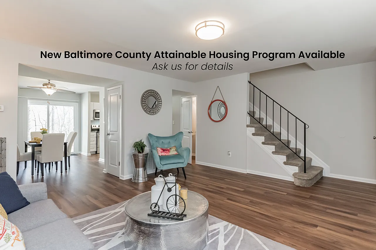 Inviting open-concept living room with modern decor, hardwood floors, and adjacent dining area in Baltimore County housing program.