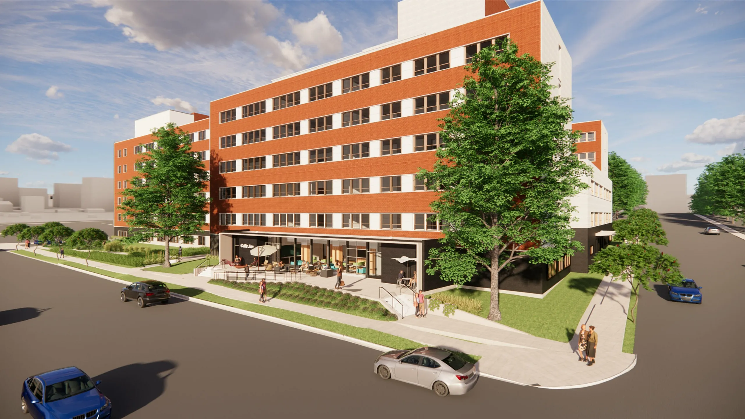 Modern residential building with vibrant red brick façade, lush greenery, and outdoor seating area on a sunny day.