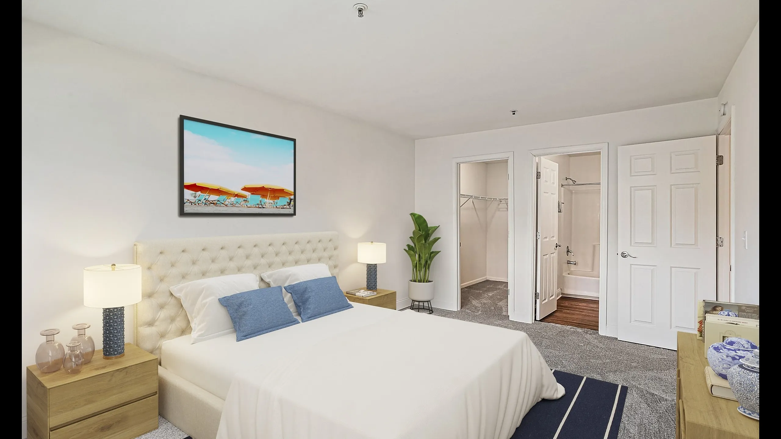 Inviting bedroom with stylish decor, featuring a plush bed, elegant nightstands, vibrant wall art, spacious walk-in closet, and connected en-suite bathroom.