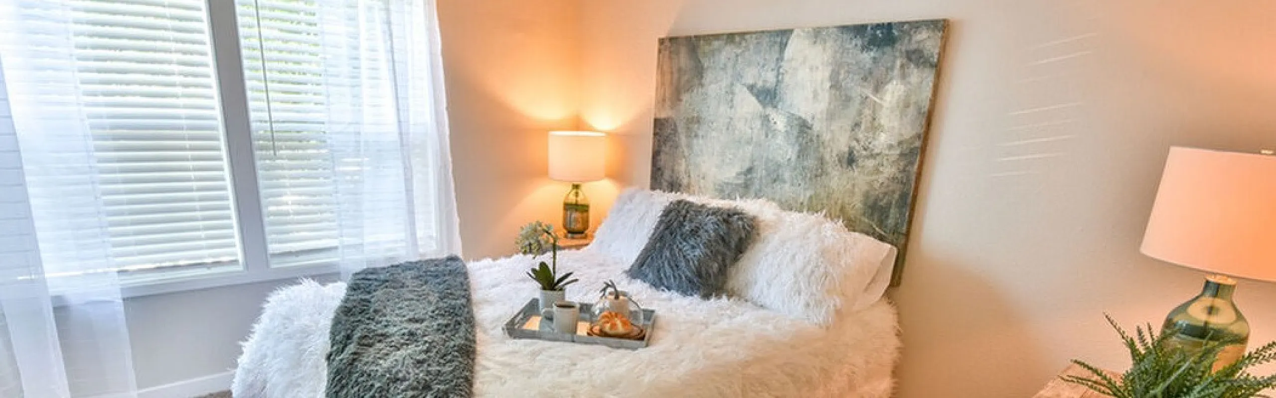 Cozy bedroom with plush bedding, stylish decor, and bright natural light, perfect for serene relaxation.