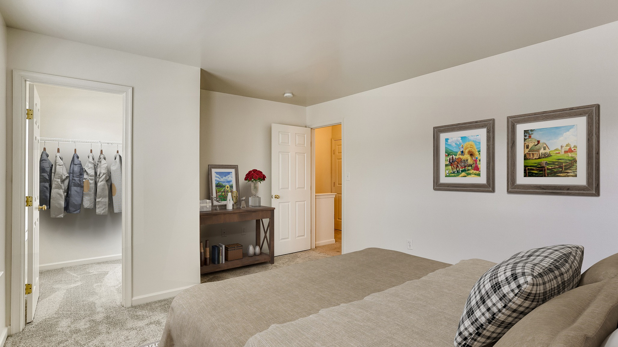 Elegant bedroom with cozy decor, featuring a spacious walk-in closet and tasteful wall art.