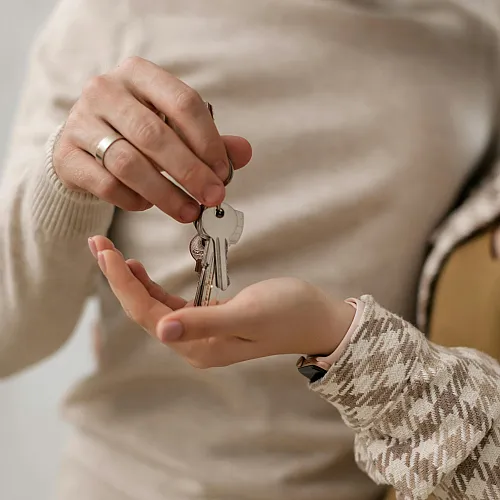 Joyful couple exchanging keys symbolizing a new beginning in their dream home, highlighting excitement and possibilities.