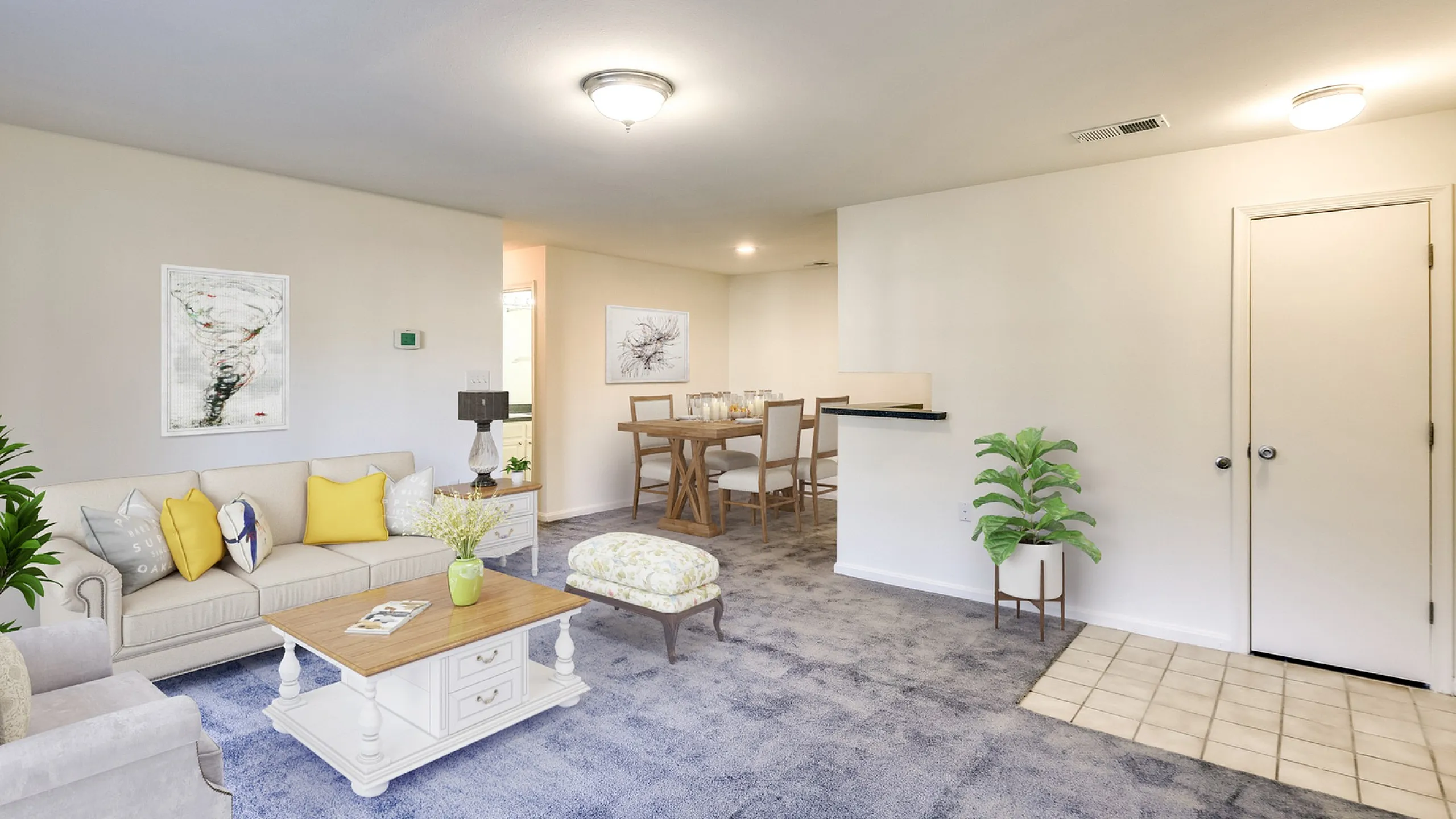 Inviting living room with plush carpet, modern furniture, and stylish decor leading to a cozy dining area.