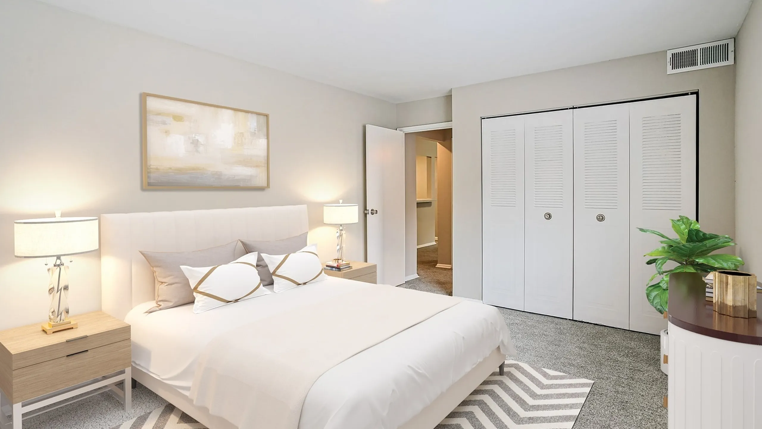 Elegant bedroom with plush carpeting, modern bedside lamps, and stylish decor accentuating cozy ambiance.
