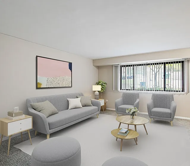 Inviting living room with modern gray sofa, cozy armchairs, and minimalist decor, bathed in natural light from large windows.