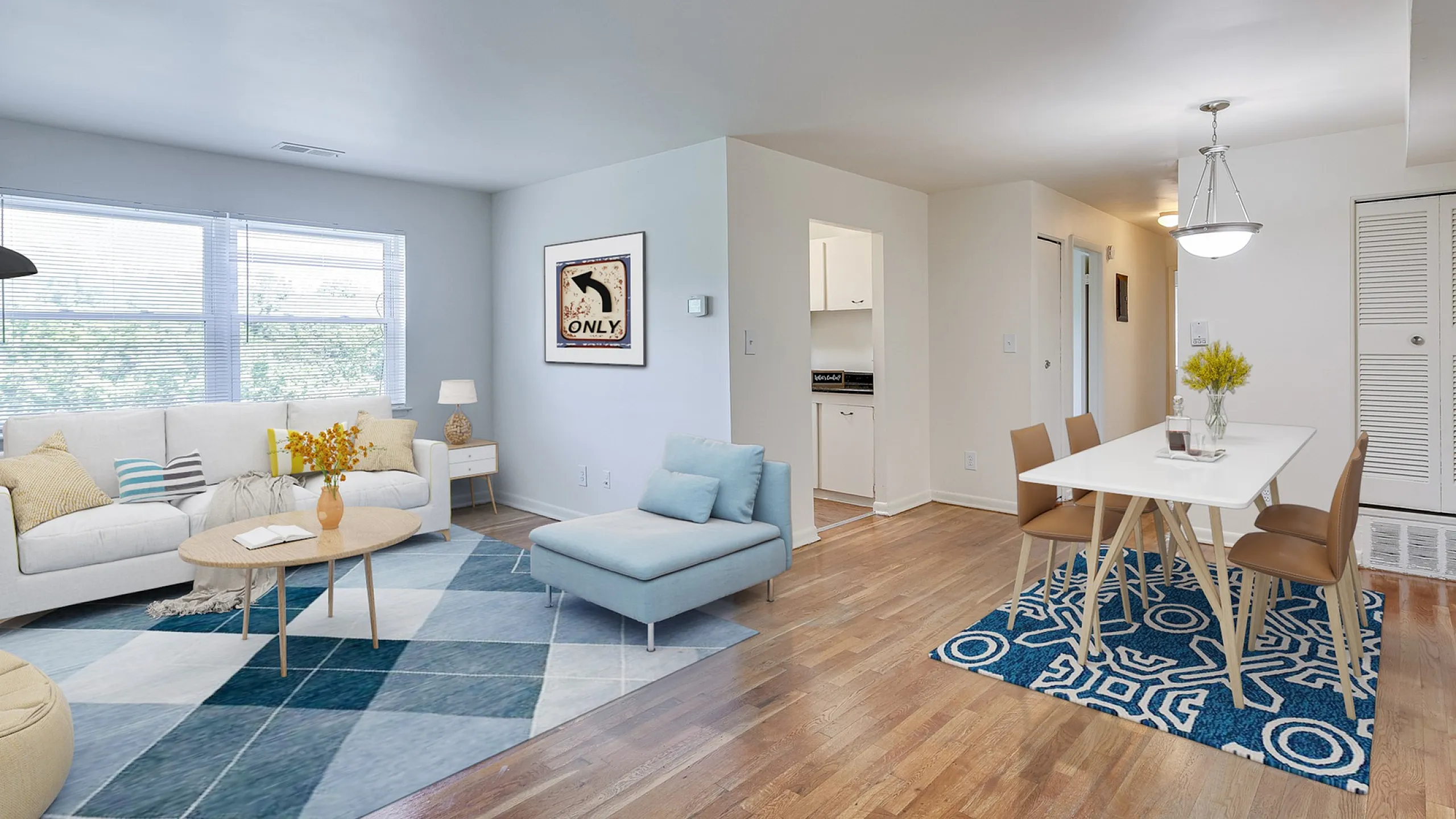 Inviting open-plan living and dining area with abundant natural light, featuring cozy seating, modern decor, and a stylish dining table against a backdrop of hardwood floors.