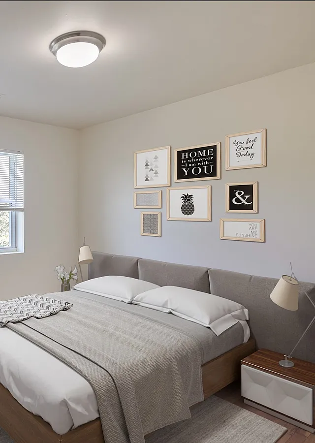 Cozy bedroom with stylish decor, a large window offering natural light, and a plush bed set against a trendy gallery wall.