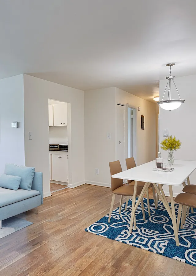 Bright and airy open-concept living and dining area with hardwood floors, stylish decor, and abundant natural light.