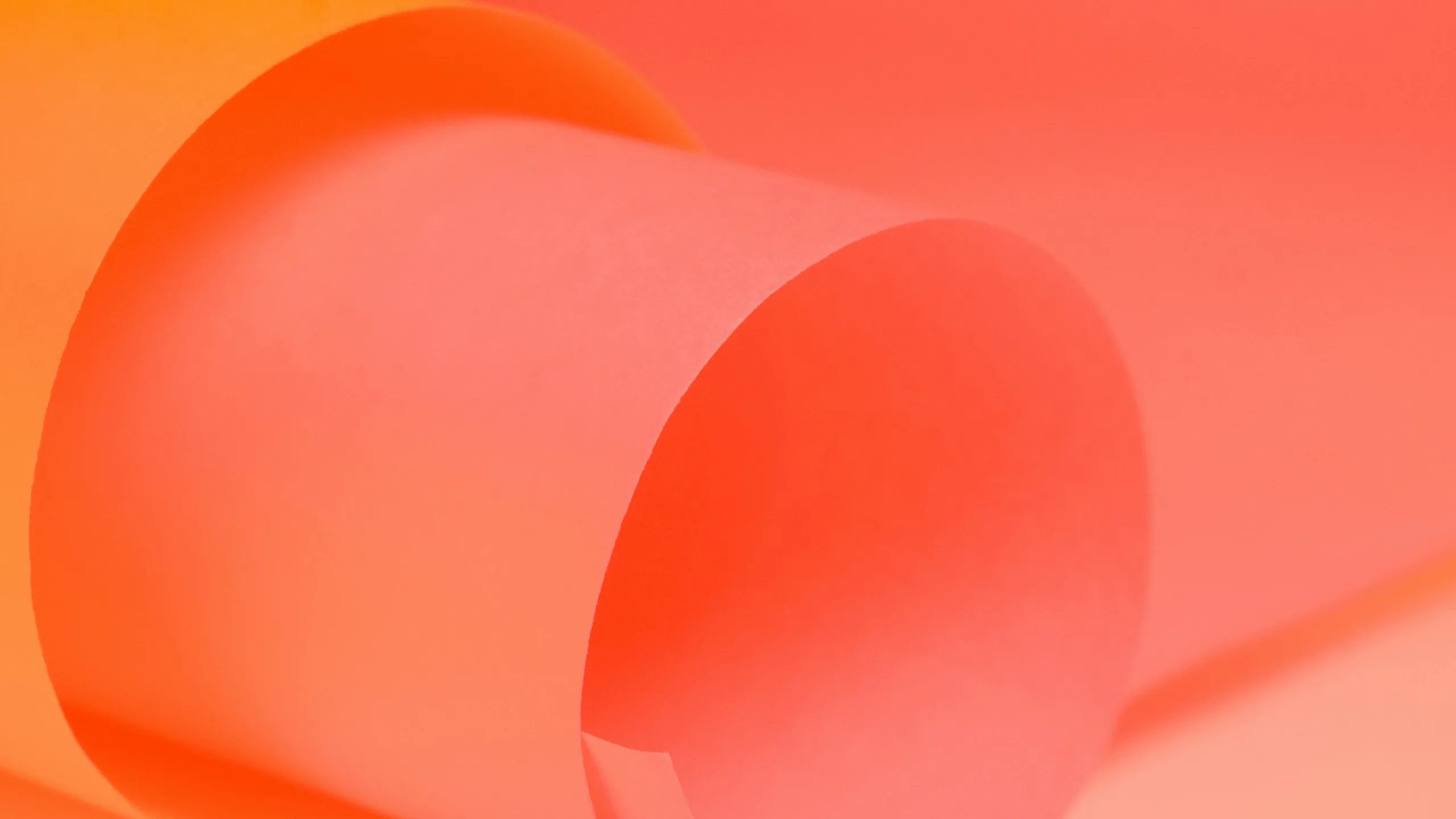 Vibrant close-up of rolled orange and pink papers creating an artistic and dynamic visual appeal.