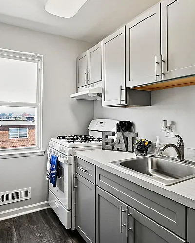 Modern kitchen with sleek cabinetry, stainless steel sink, and a large window offering natural light.