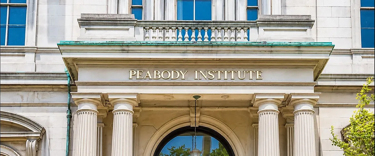 Elegant historical building facade with classic columns and ornate architectural details.