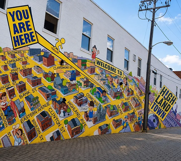 Vibrant mural showcasing Highlandtown map with lively streets and cheerful characters, perfect for exploring urban art and community spirit.