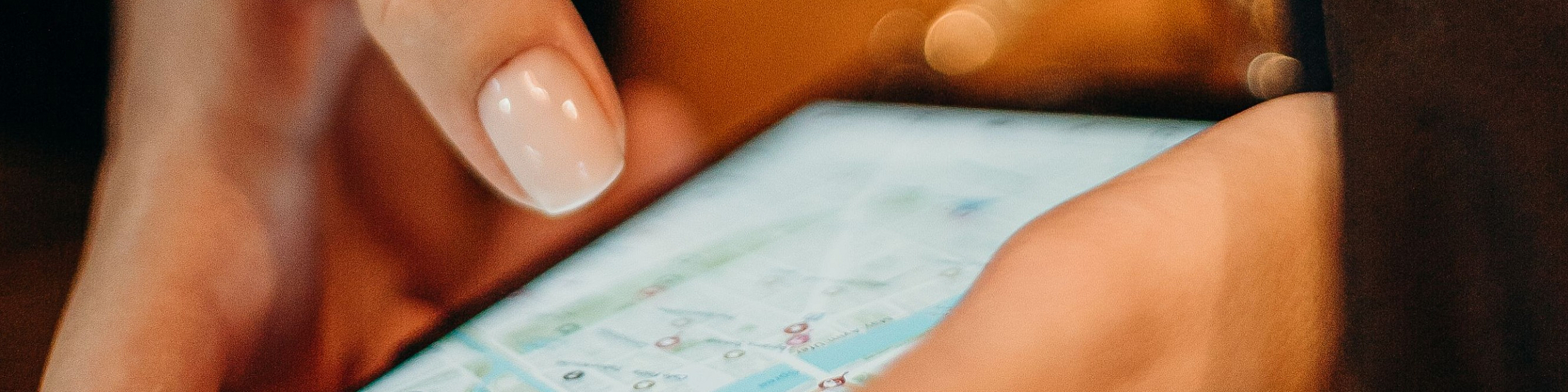 Close-up of a person using a smartphone with a map application, highlighting a modern lifestyle with convenient navigation.