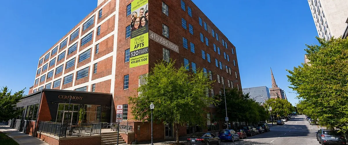 Charming urban apartment building with modern windows and a vibrant neighborhood view, offering studio and 1-2 bedroom units at 520 Park.