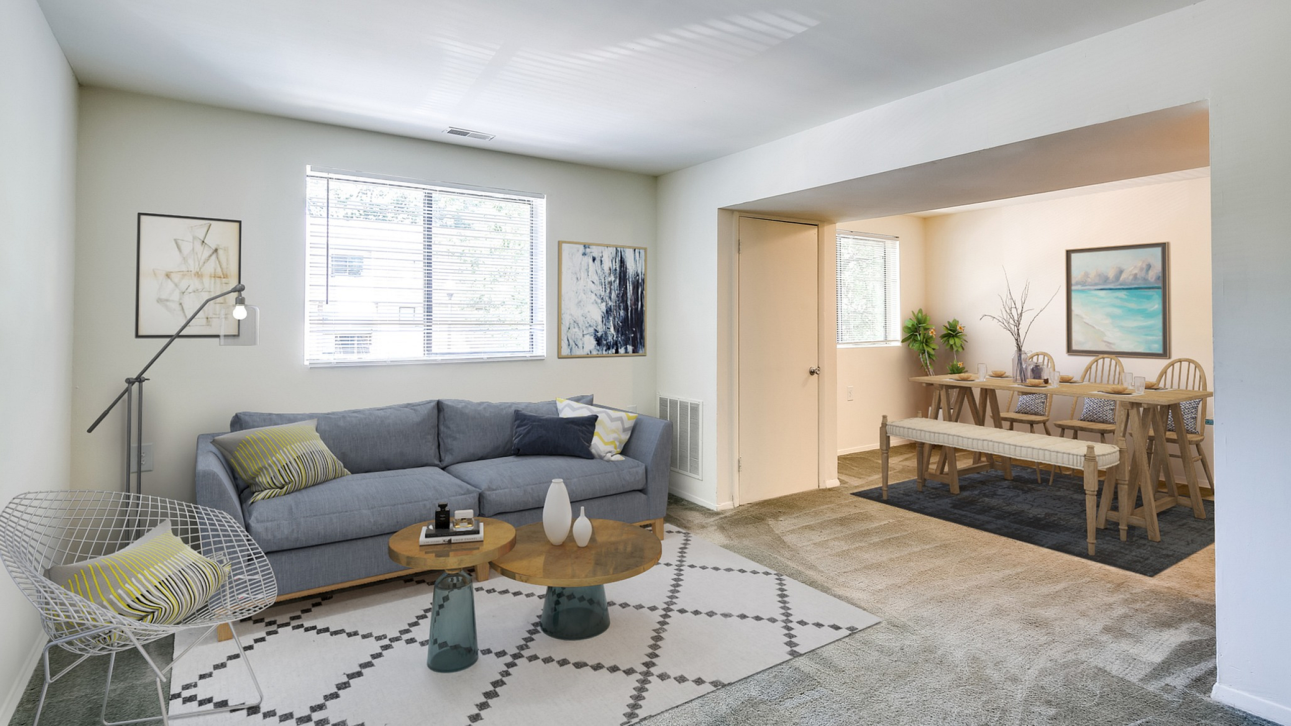 Inviting living and dining area featuring a cozy gray sofa, chic modern decor, and a spacious dining table perfect for entertaining.