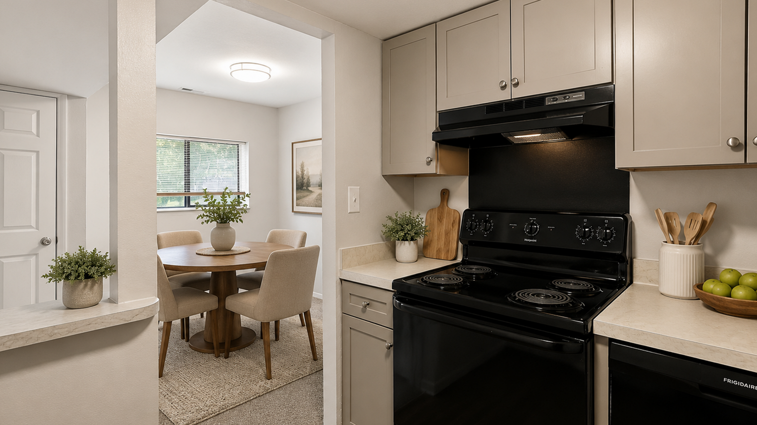 Charming kitchen with modern appliances and view into a cozy dining area featuring natural lighting and elegant decor.
