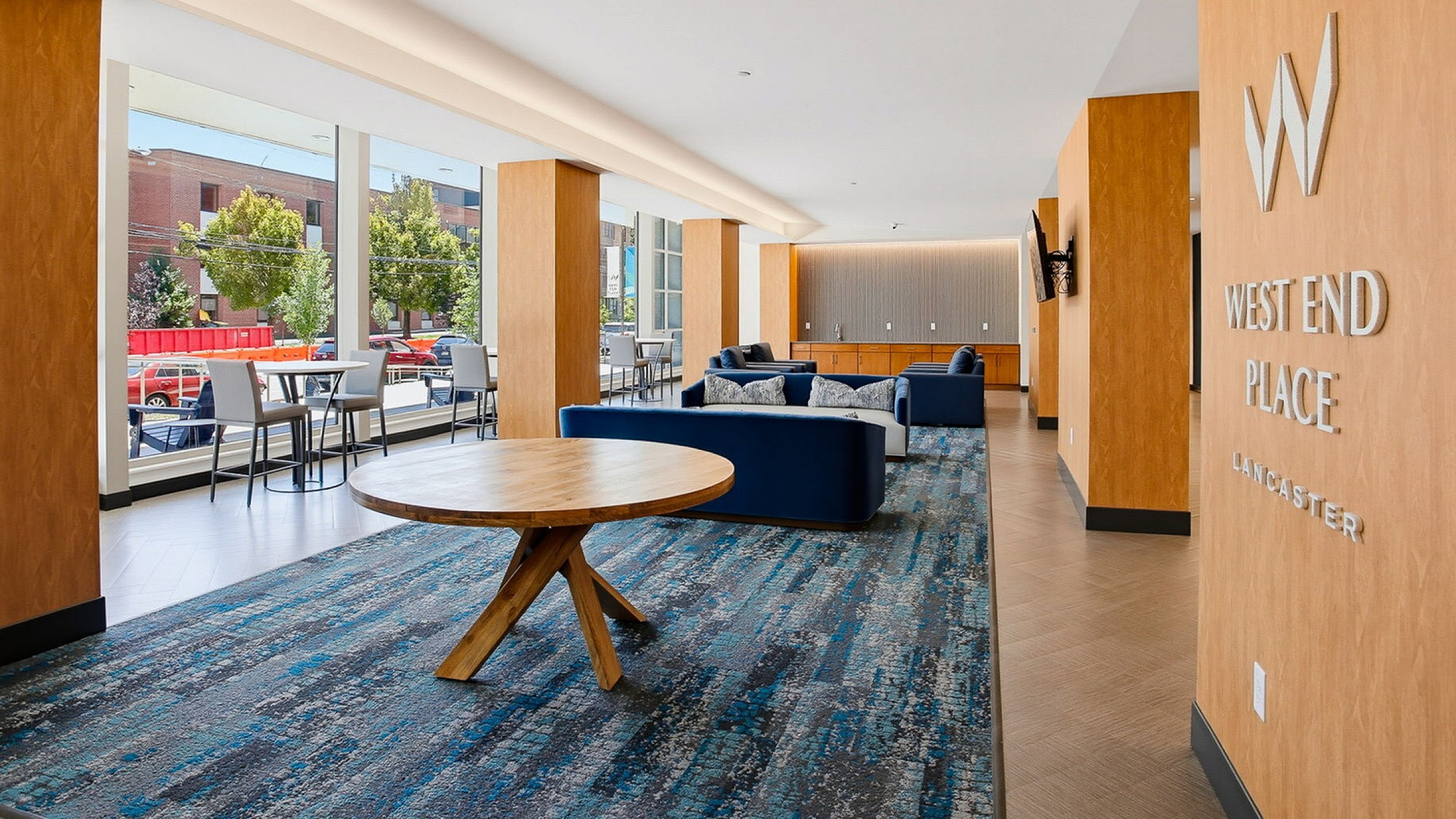 Elegant modern lobby at West End Place featuring stylish seating, large windows, and natural light in Lancaster.