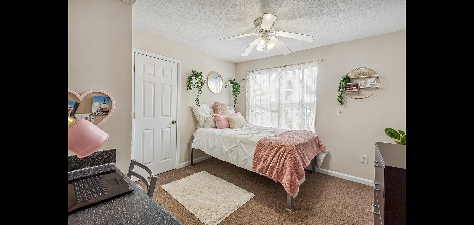 Bright and cozy bedroom with a plush bed, stylish decor, and abundant natural light, perfect for relaxation and comfort.