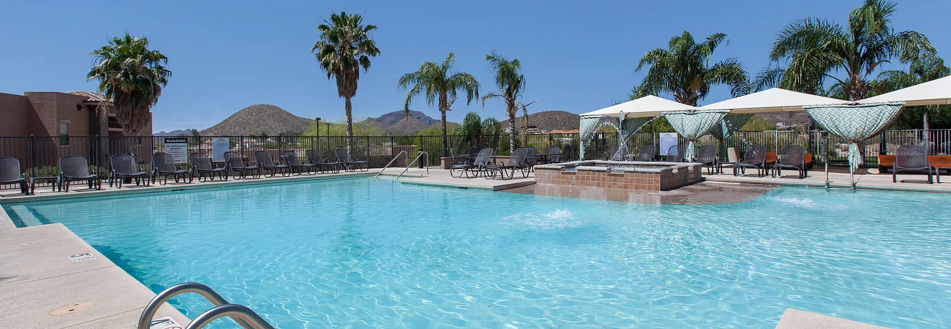campus crossings at star pass pool area with cabanas and lounge chairs