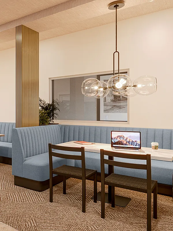 campus crossings briarlciff studio lounge area with booth, tables, chairs.