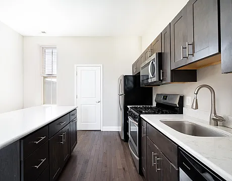 university city associates 4102 walnut street renovated kitchen area with white countertops and stainless steel appliances