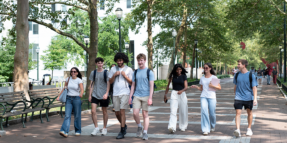 students walking down locust walk with books in hand. university city philadelphia upenn