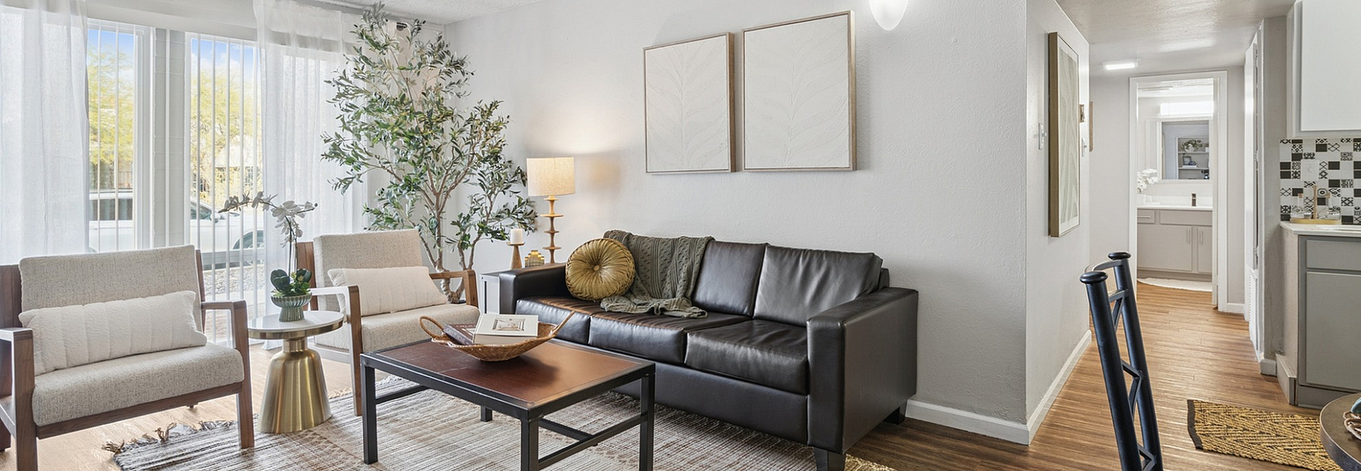 Inviting living room with natural light, comfortable seating, and modern decor.