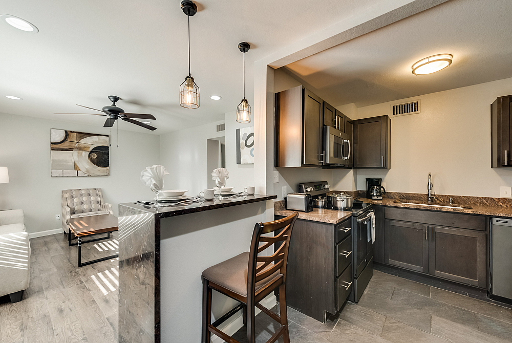 Elegant open-concept kitchen with modern appliances and stylish dining area leading to a cozy living space.