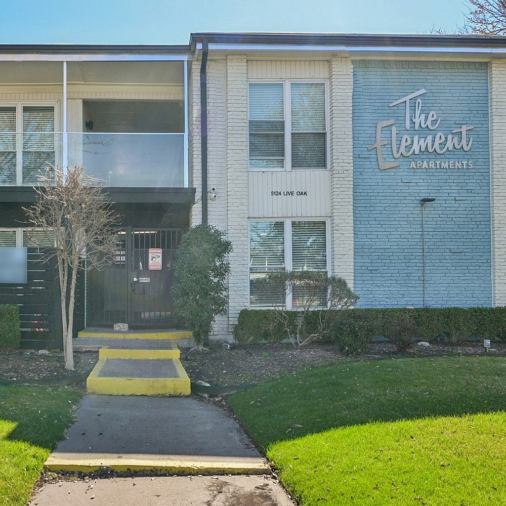 Inviting apartment complex with modern design, featuring a well-maintained exterior and lush green landscaping at The Element Apartments.