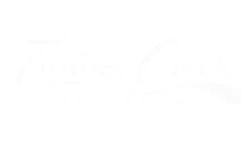 Elegant logo for Timber Creek Apartments, featuring stylized text with a flowing underline.