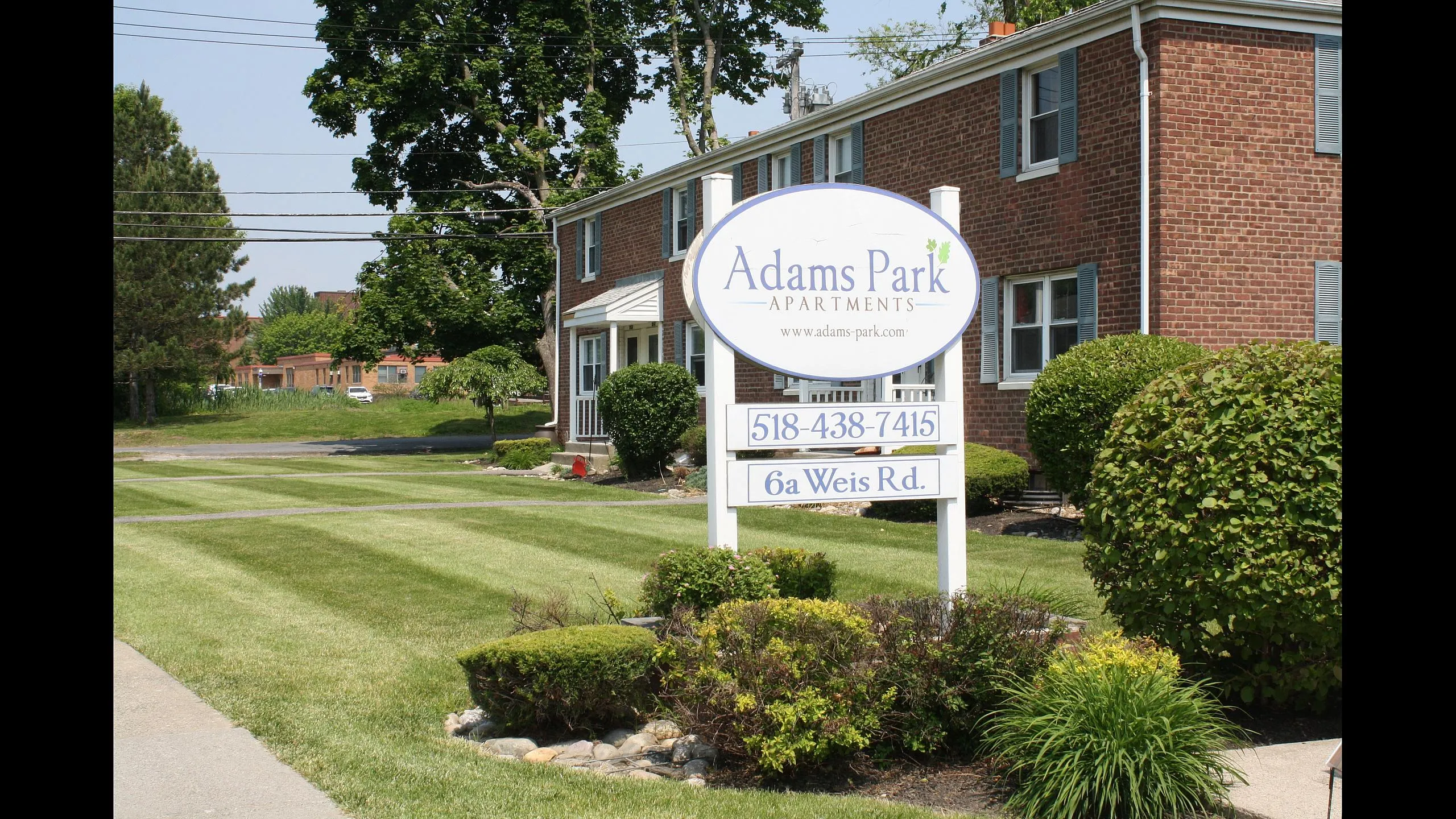 Adams Park Apartments entrance sign on Weis Road in Albany, NY