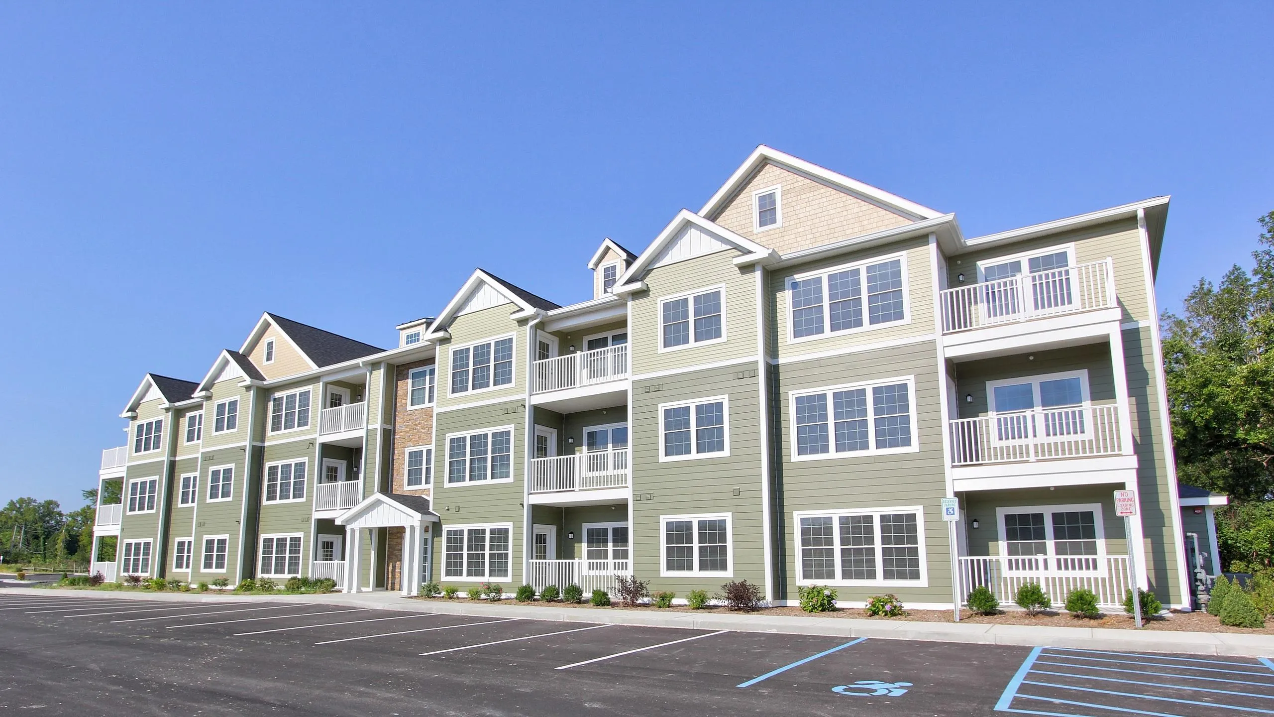 Three-story apartment building with balconies at Mohawk Riverfront Apartments in Cohoes, NY