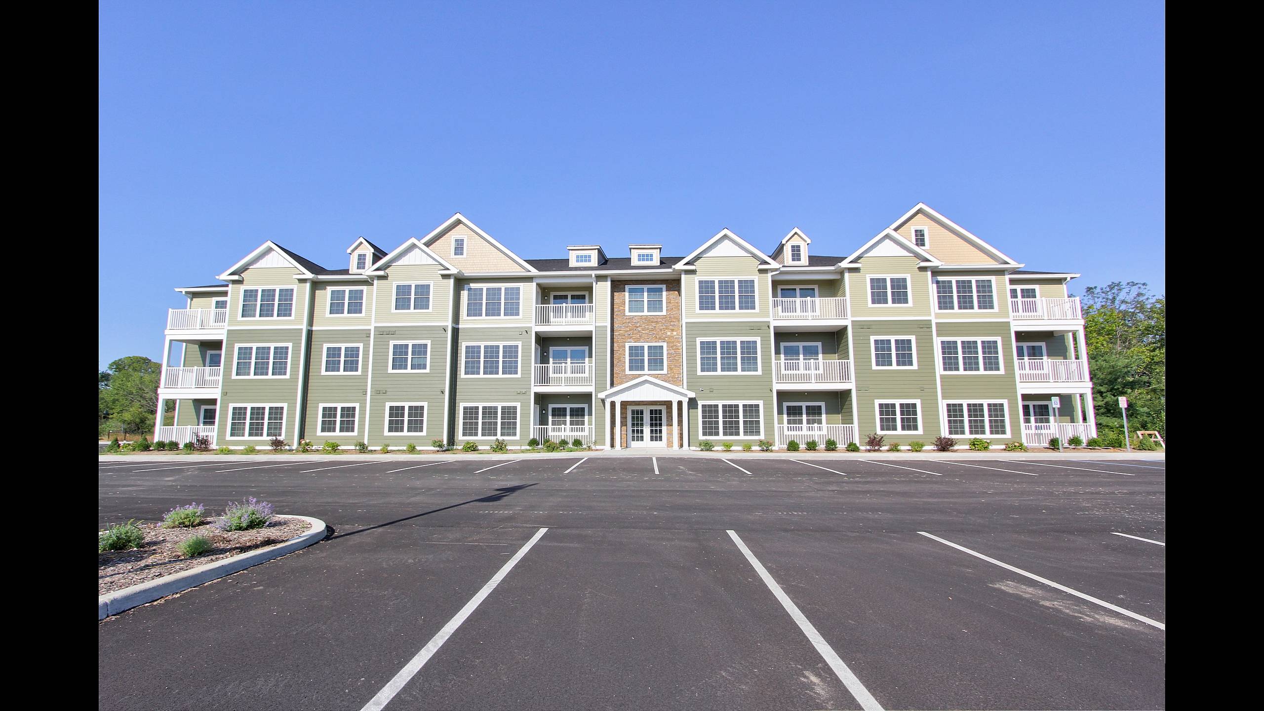 Resident parking and building entrance at Mohawk Riverfront Apartments in Cohoes, NY