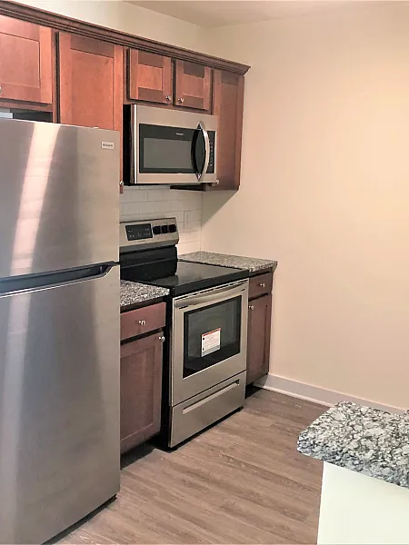 Kitchen with granite countertops and stainless steel appliances at Sunrise Solars Apartments