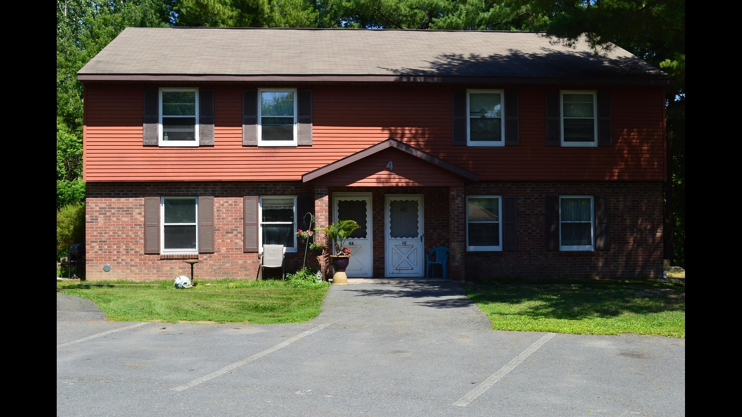 Brick apartment building with private entrances at Pine Park Terrace Apartments