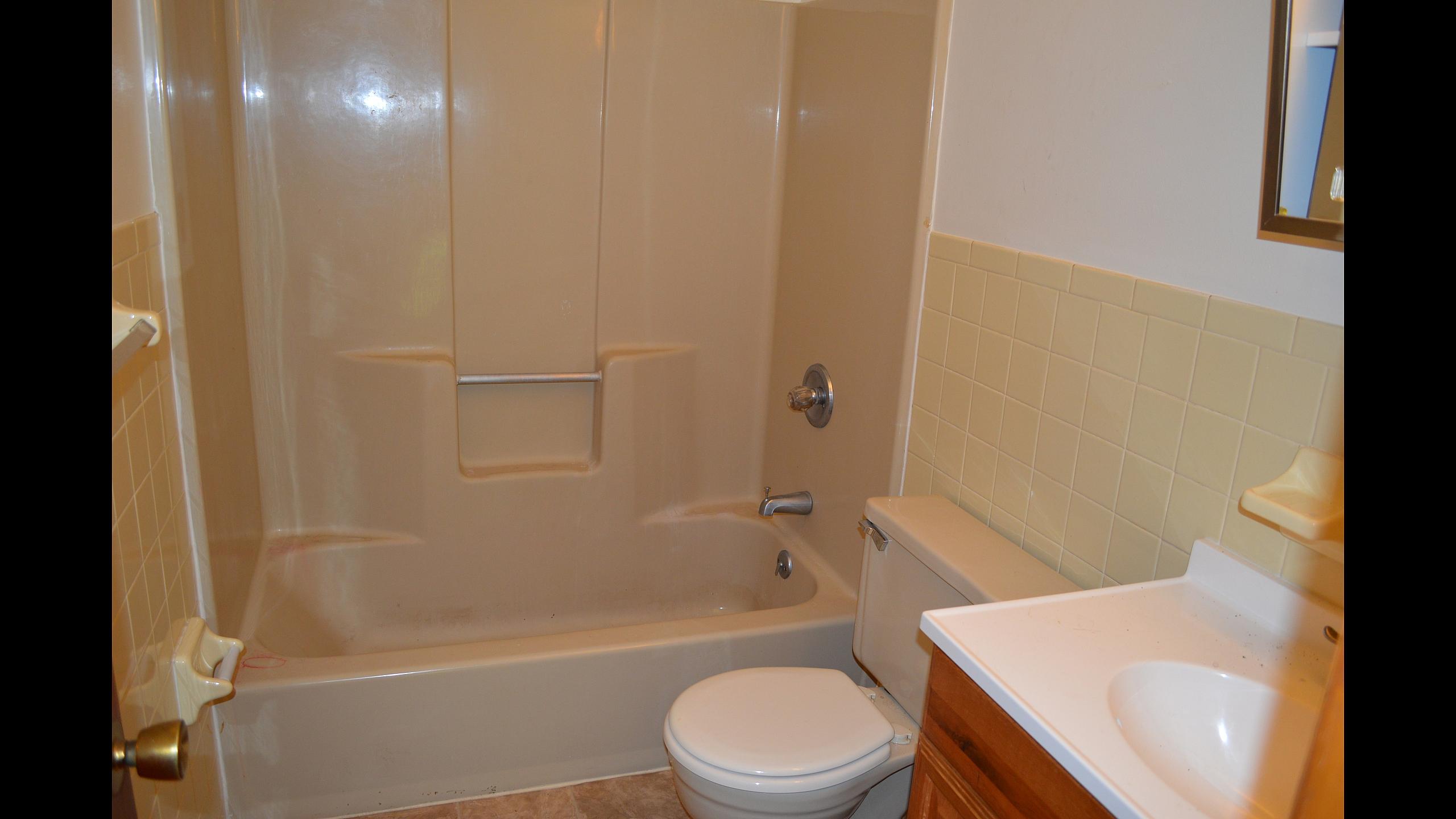 Full bathroom with tub and shower surround at Pine Park Terrace Apartments