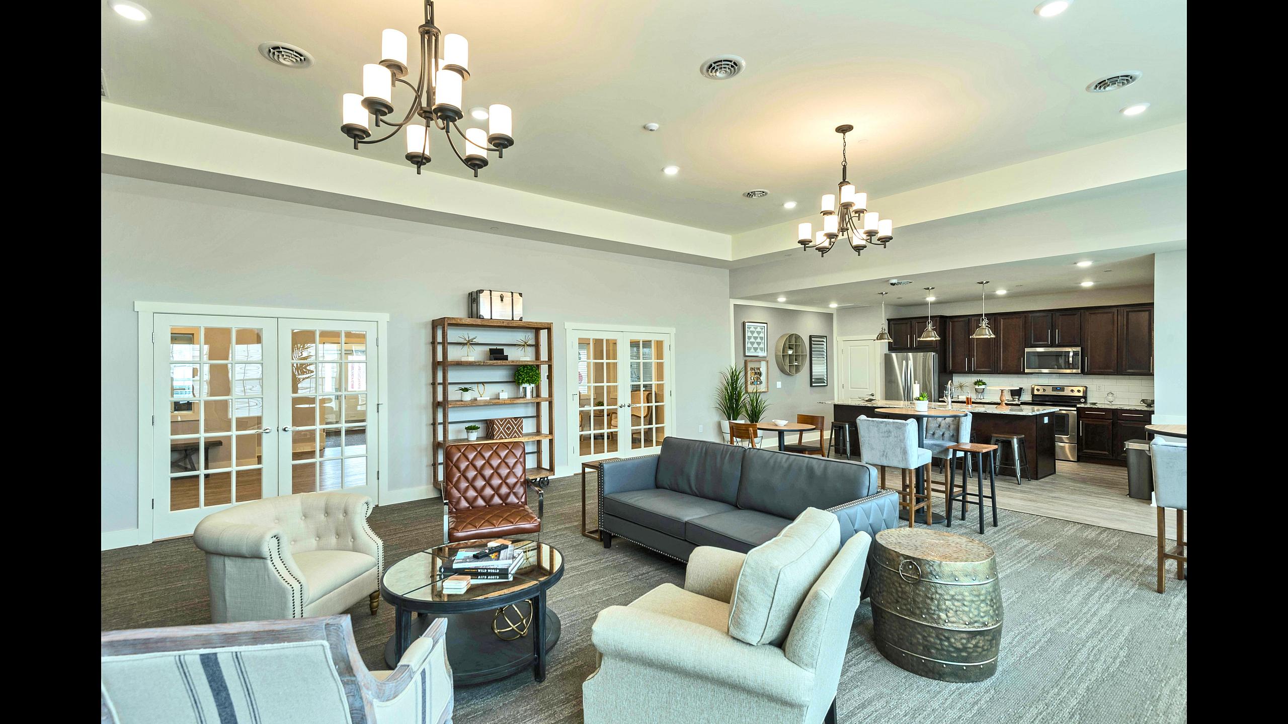 Resident clubhouse with lounge seating, dining area and kitchen at Van Allen Apartments
