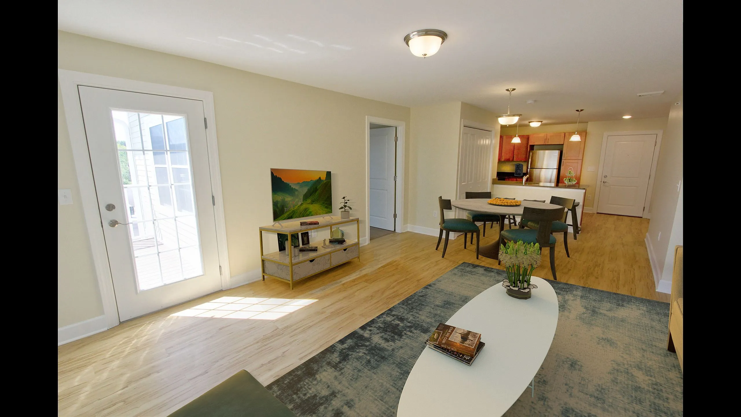 Open dining and living area with sliding door to a private patio at Timber Creek Apartments
